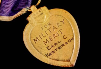 The back of the Purple Heart. It looks like his name was hand engraved.